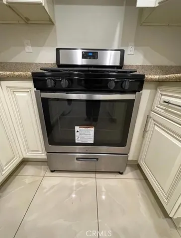 a stove top oven sitting inside of a kitchen