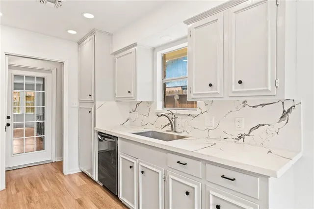 a bathroom with a sink and cabinets