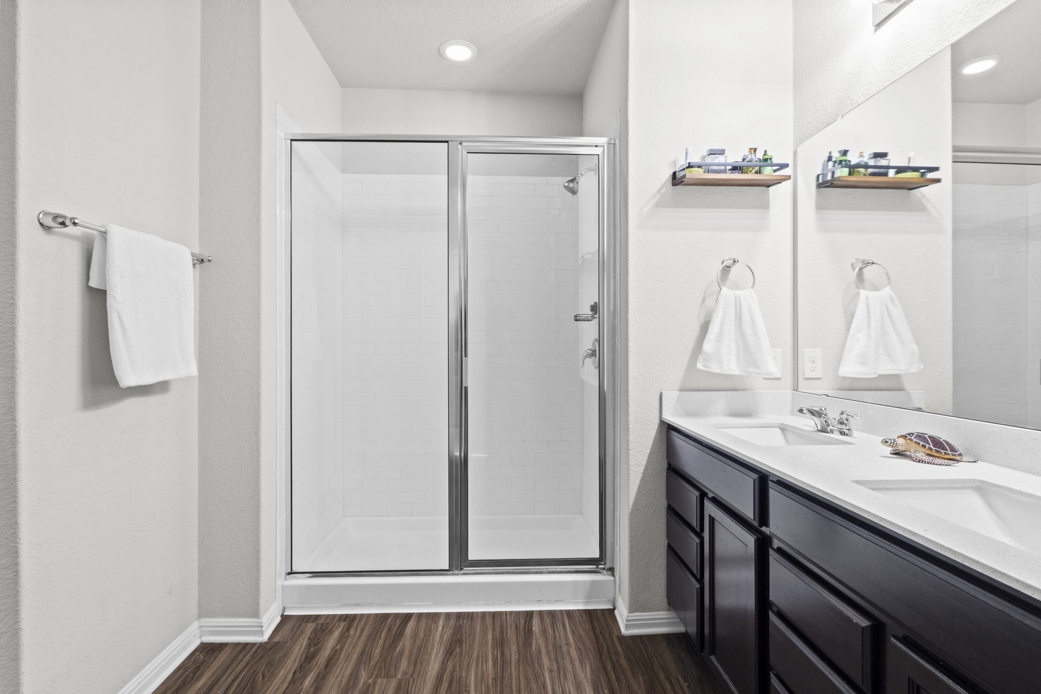 2417 Bridges Ranch Road Georgetown, TX 78628 - Photo 8 of 36 Bathroom featuring double vanity, a stall shower, dark wood finished floors, and recessed lighting