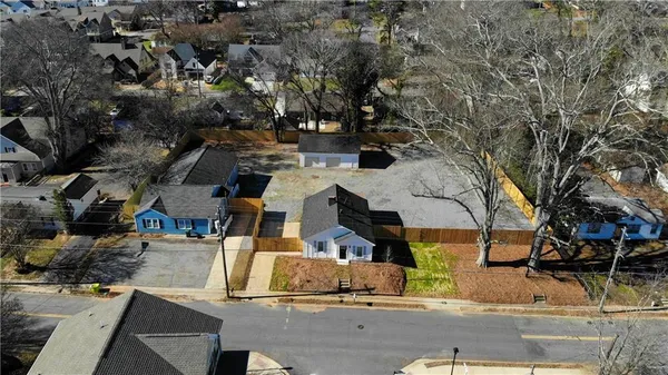an aerial view of a house with a yard