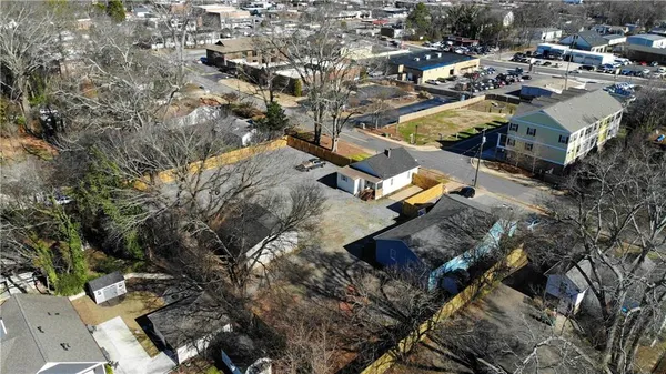an aerial view of multiple houses with yard