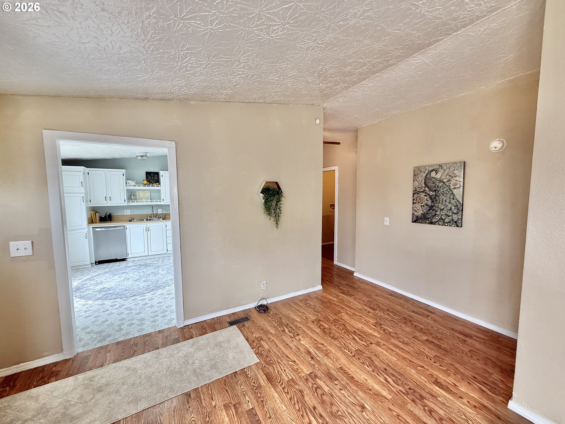1282 3rd Street, Unit 37 Lafayette, OR 97127 - Photo 5 of 28 wooden floor in an empty room and a kitchen