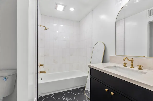 a bathroom with a tub sink and mirror
