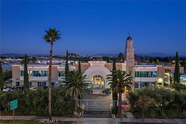 a view of multiple houses with palm trees