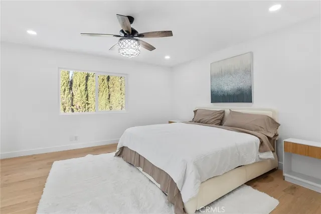 a bedroom with a bed and a chandelier