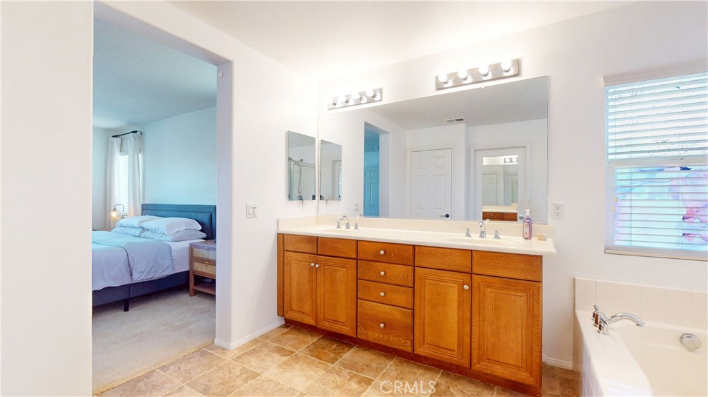 1279 Longbranch Road San Jacinto, CA 92582 - Photo 15 of 35 a spacious bathroom with a double vanity sink and a mirror