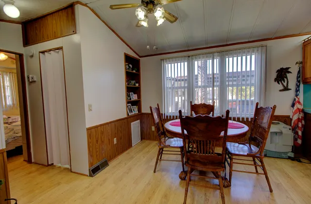 a view of a dining room with furniture and window