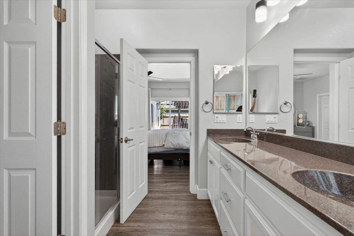 437 Silver Ridge Court Oakdale, CA 95361 - Photo 22 of 41 a en suite bathroom with a granite countertop double vanity sink mirror and