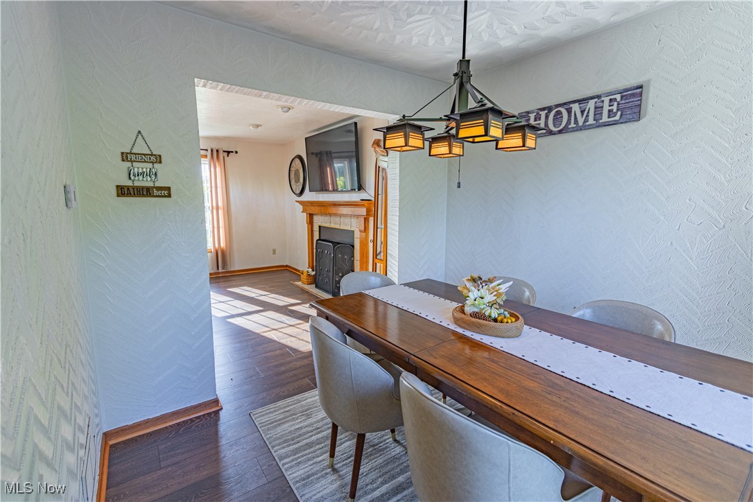 2121 South Cleveland Massillon Road Akron, OH 44321 - Photo 9 of 26 Dining room with a tiled fireplace and hardwood / wood-style flooring