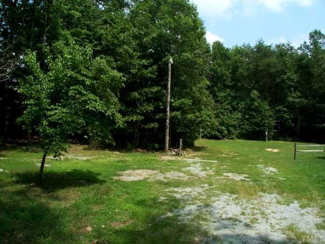 7422 Jock Road Bahama, NC 27503 - Photo 2 of 12 a tall tree in middle of green field