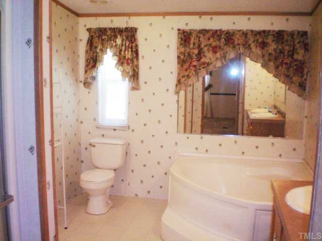 7422 Jock Road Bahama, NC 27503 - Photo 9 of 12 a bathroom with a sink toilet and shower
