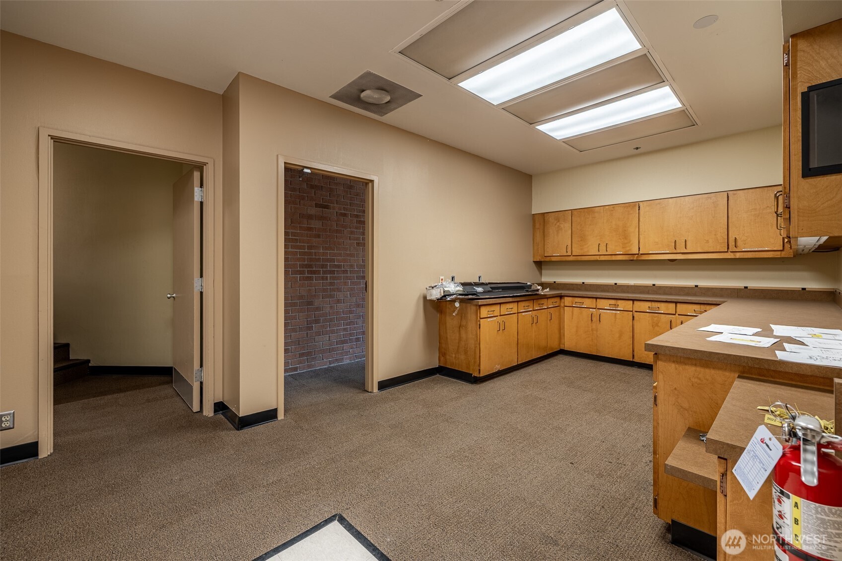 30 South Mission Street, Unit B Wenatchee, WA 98801 - Photo 12 of 16 a kitchen with stainless steel appliances a refrigerator and a stove
