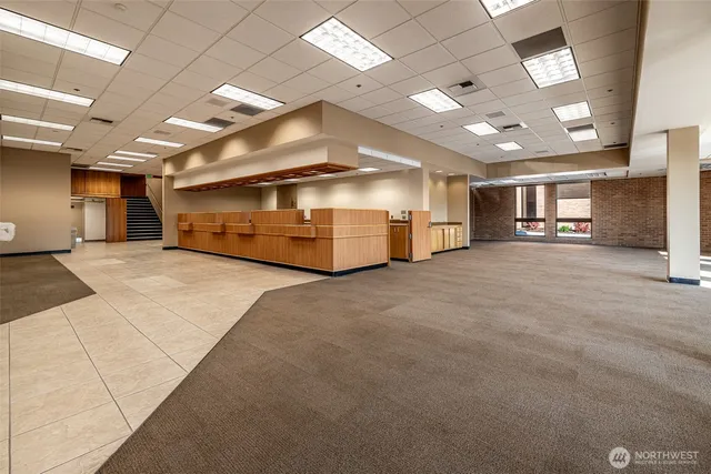 a view of a livingroom with furniture and a window