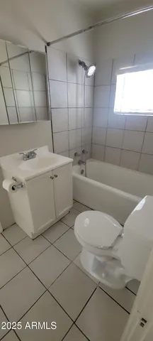 a bathroom with a sink a toilet and bathtub