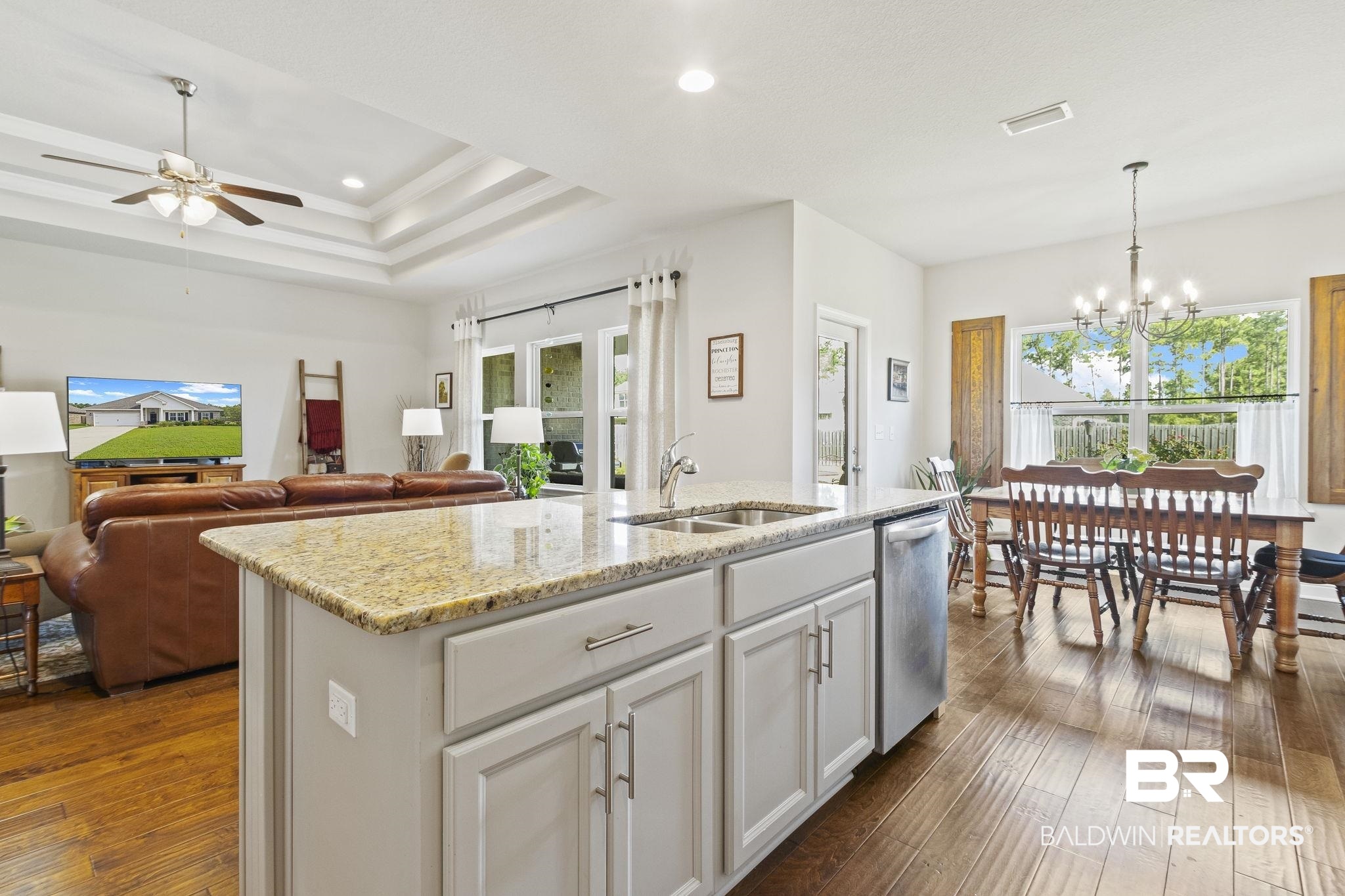 31663 Kestrel Loop Daphne, AL 36527 - Photo 27 of 86 Kitchen featuring ceiling fan with notable chandelier, dishwasher, sink, dark wood-type flooring, and a center island with sink