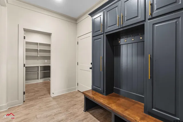 a view of a kitchen with fridge and wooden floor