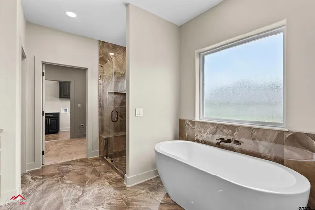 a bathroom with a bathtub and a shower