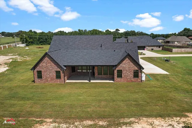an aerial view of residential houses with outdoor space and swimming pool