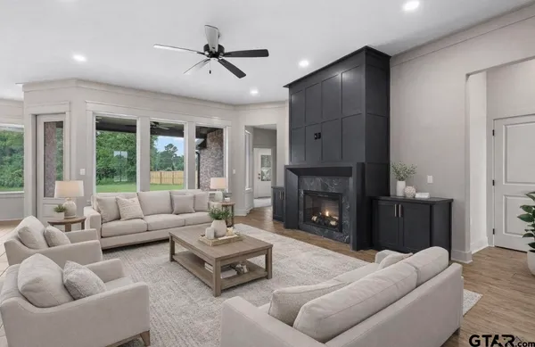 a view of empty room with cabinet and a fireplace