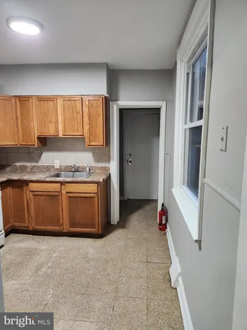a kitchen with a stove a sink and a refrigerator