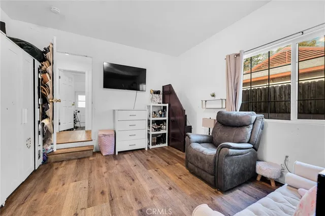 a bedroom with furniture and a flat screen tv