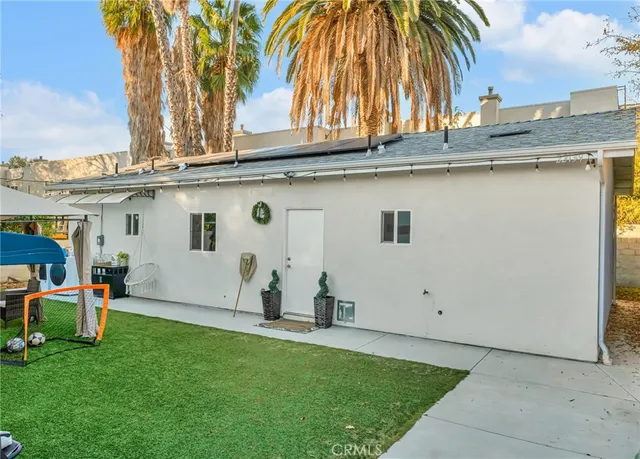 a front view of a house with a garden and yard
