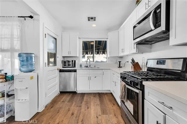 a kitchen with a stove oven and sink