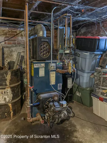 a room with water heater and a wooden floor