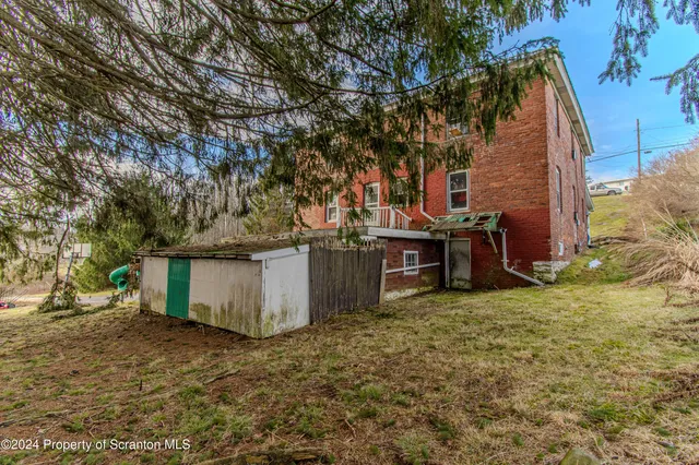 a view of a backyard with large trees