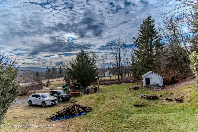 a view of a yard with cars