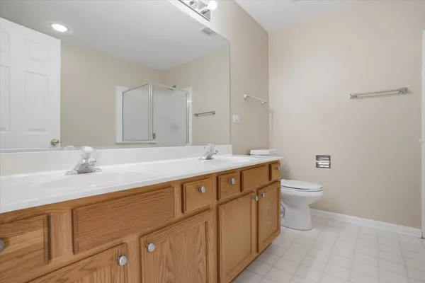 a bathroom with a granite countertop sink a toilet and a mirror