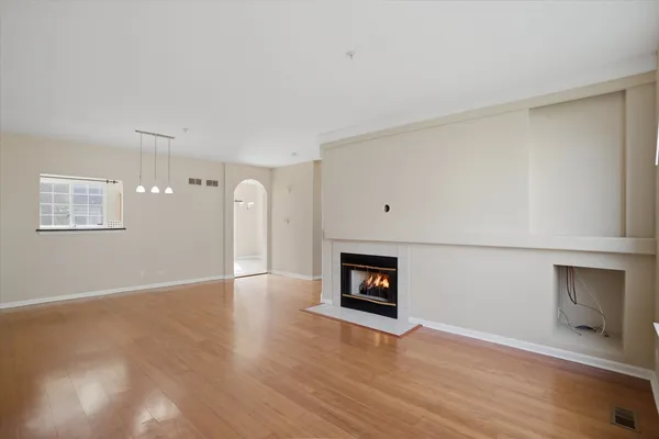 a view of a room with wooden floor and fireplace