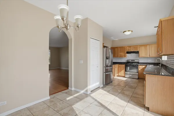 a kitchen with stainless steel appliances granite countertop a refrigerator and a sink