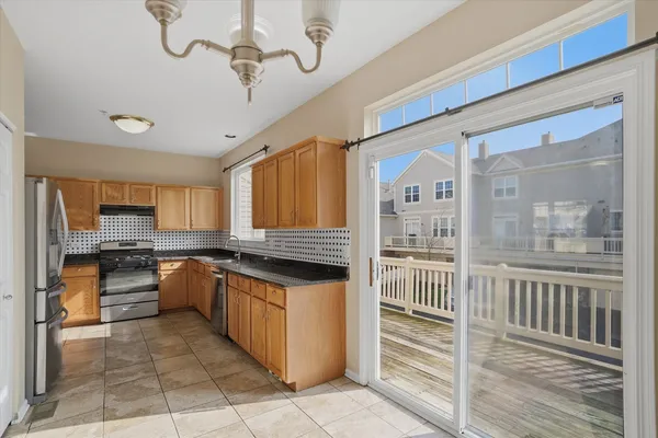 a kitchen with stainless steel appliances granite countertop a stove and a refrigerator