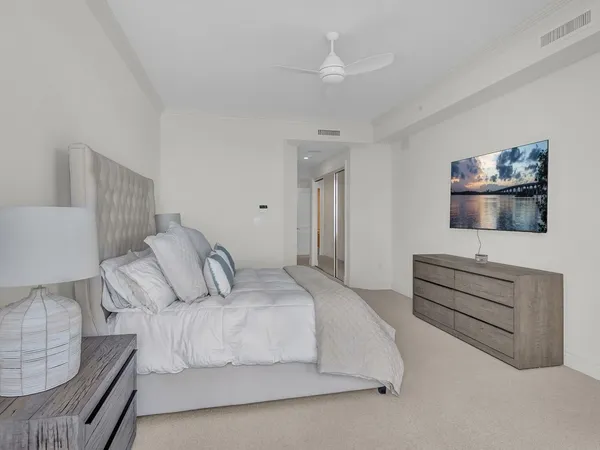 a bedroom with a bed and a flat screen tv