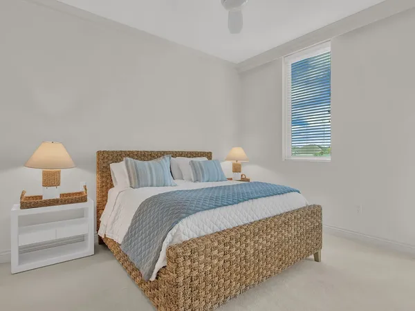 a bedroom with a bed and a lamp