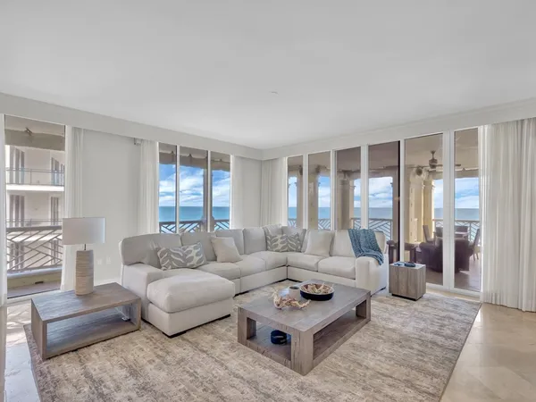 a living room with furniture a rug and a large window