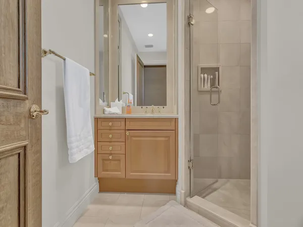 a bathroom with a shower sink and mirror