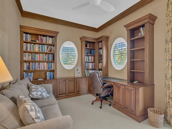 a living room with furniture and a clock