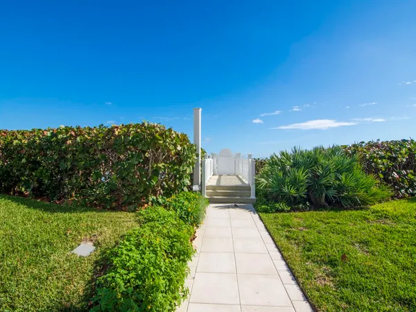a view of a pathway both side of grassy field