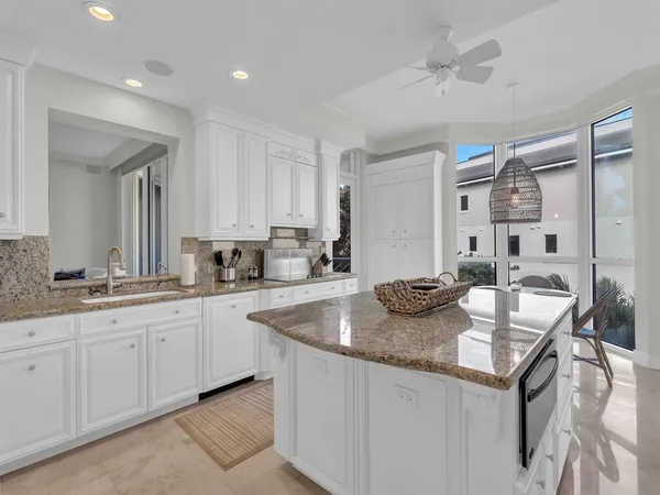 a kitchen with granite countertop a sink and cabinets
