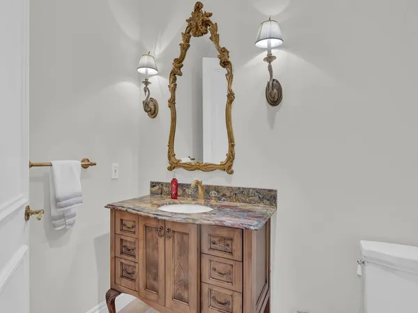 a bathroom with a sink vanity and a mirror