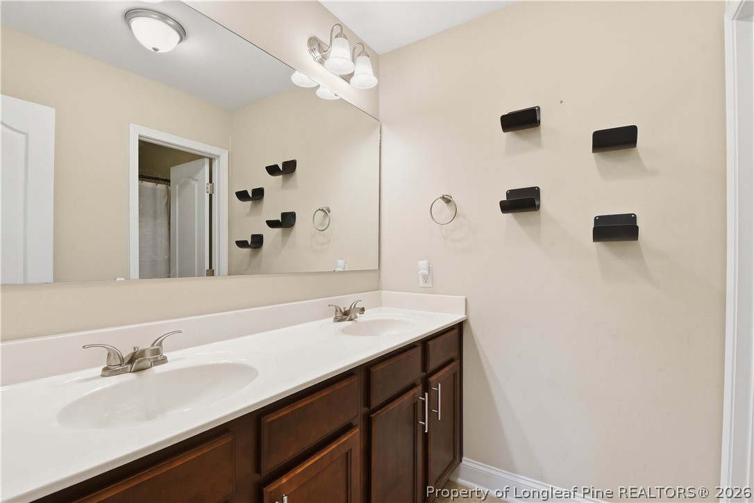 140 Birch Avenue Spring Lake, NC 28390 - Photo 32 of 49 a bathroom with a sink double vanity granite and shower