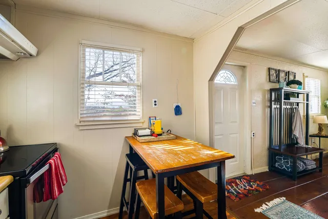 a view of kitchen with stainless steel appliances refrigerator stove and wooden floor