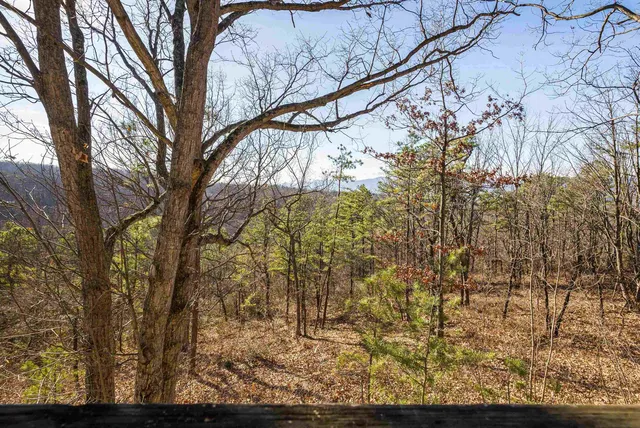 a wooden bench sitting in front of a house