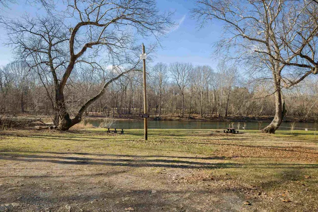 a view of a lake with wooden stairs and bench