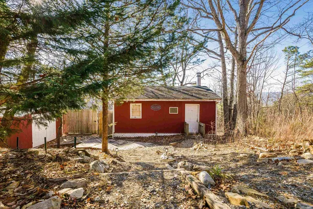 a backyard of a house with table and chairs