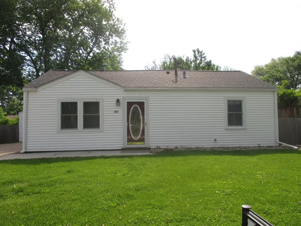 a front view of house with a garden