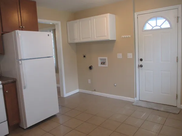 a view of cabinets with refrigerator and cabinet