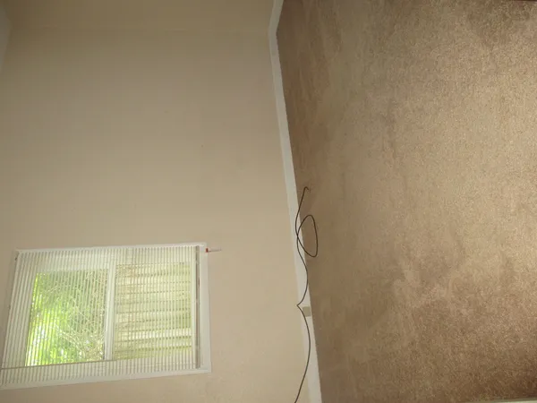 a view of a room with tiles and a window